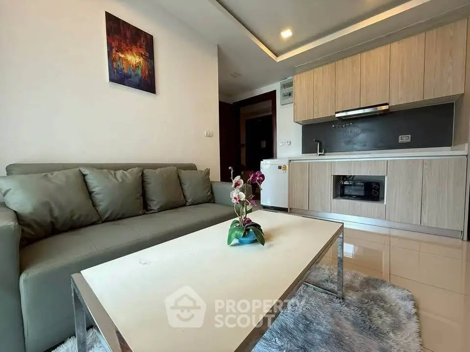 Modern living room with sleek kitchen and stylish decor