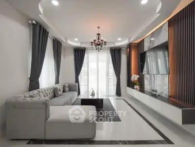 Luxurious modern living room with elegant chandelier and plush sectional sofa