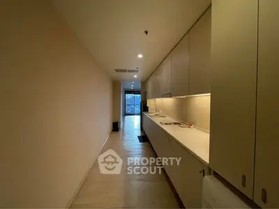 Sleek modern kitchen with ample storage and minimalist design in a contemporary apartment.