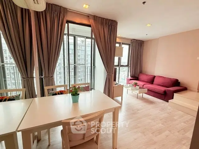 Spacious modern living room with large windows and balcony view