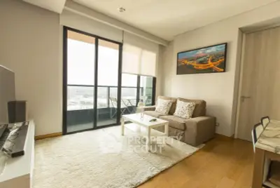 Modern living room with balcony view and cozy seating area