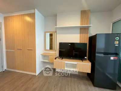 Modern living room with TV, sleek cabinets, and stylish decor