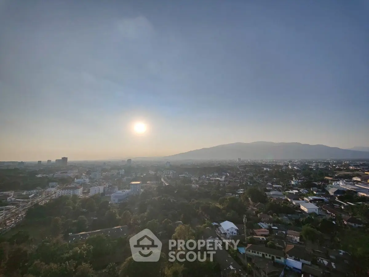 Stunning panoramic cityscape with mountain backdrop and sunset view, perfect for urban living enthusiasts.