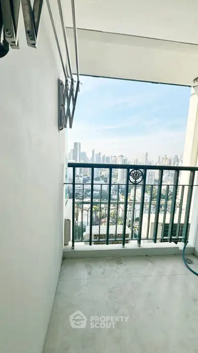 Spacious balcony with stunning city skyline view, perfect for relaxation and enjoying urban living.