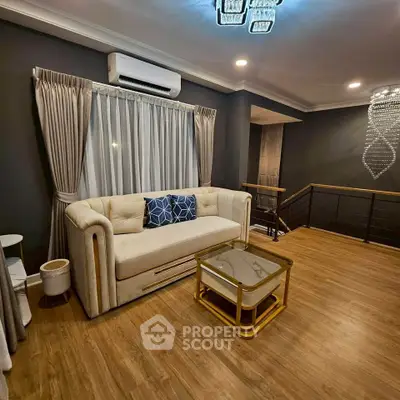 Elegant living room with modern decor and stylish lighting, featuring a plush sofa and chic coffee table.
