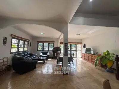 Spacious living room with elegant furniture and large windows for natural light.