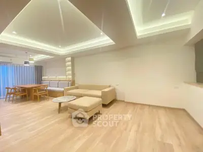 Spacious modern living room with elegant lighting and wooden flooring