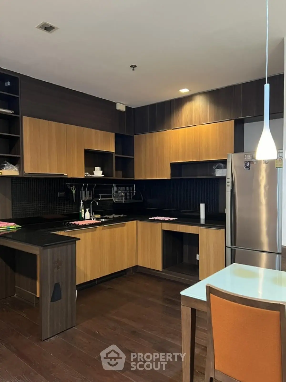 Modern kitchen with sleek wooden cabinets and stainless steel appliances