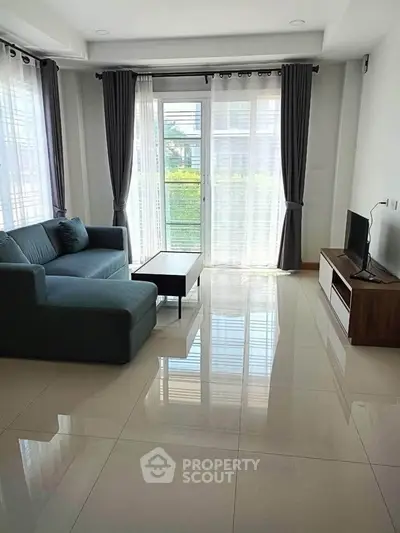 Spacious living room with modern sofa and large windows for natural light