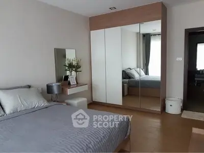 Modern bedroom with stylish decor and mirrored wardrobe