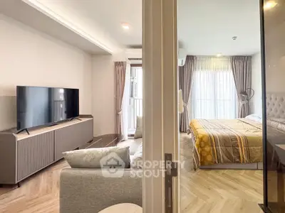Modern apartment interior with cozy living room and stylish bedroom, featuring elegant decor and natural light.
