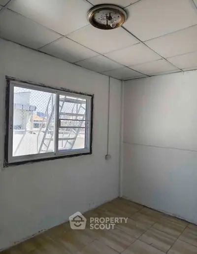 Bright room with window and tiled floor, ideal for customization.