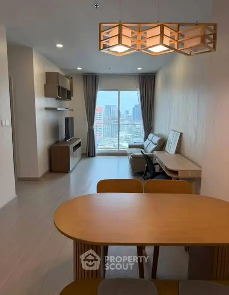Modern living room with city view, stylish furniture, and elegant lighting in a high-rise apartment.