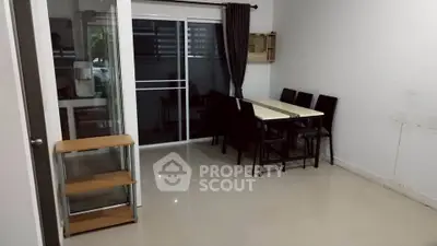 Spacious dining area with modern table and chairs, sliding glass doors leading to a balcony, perfect for entertaining.