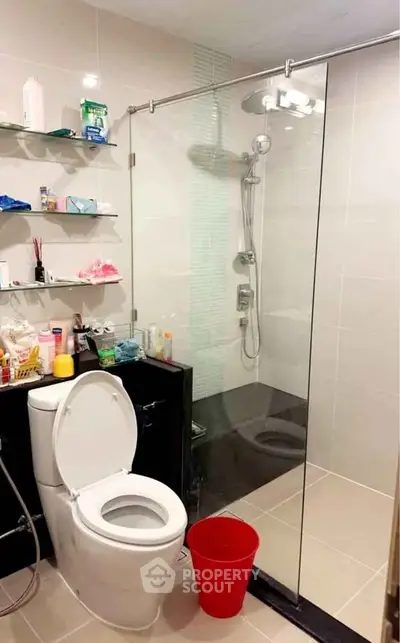 Modern bathroom with glass shower and sleek fixtures in a contemporary home.