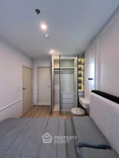 Modern bedroom with open wardrobe and cozy bed in stylish apartment