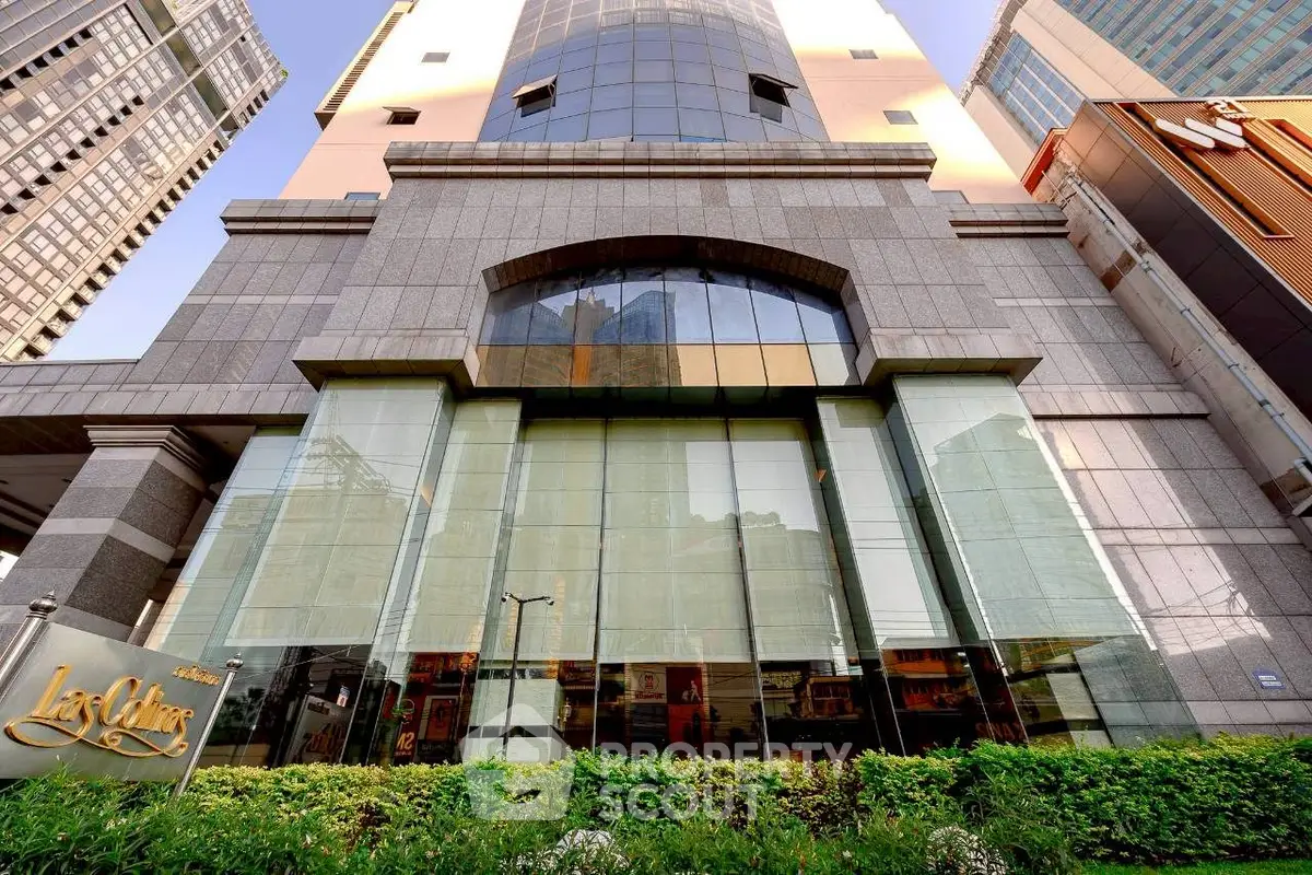 Stunning modern building exterior with glass facade in prime urban location.
