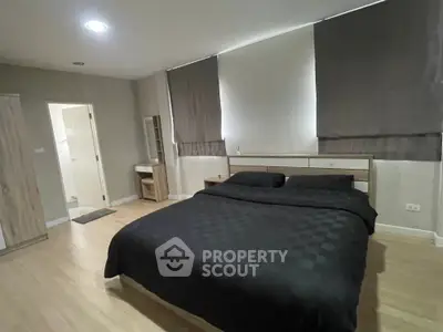 Spacious modern bedroom with ensuite bathroom and stylish decor