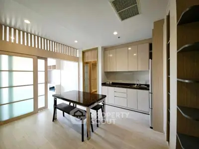 Modern kitchen with sleek cabinets and dining area in open layout
