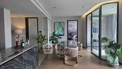 Luxurious modern living room with elegant decor and open layout, featuring a stylish bar area and large windows.