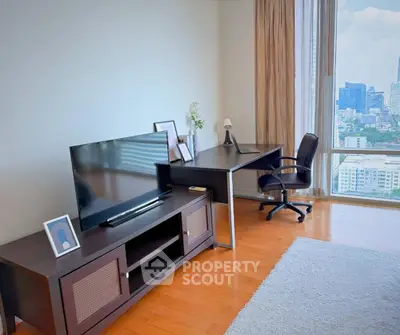 Modern study room with city view, featuring sleek desk and TV setup.