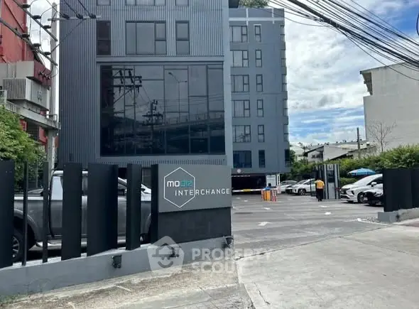 Modern urban building with parking area and sleek architectural design