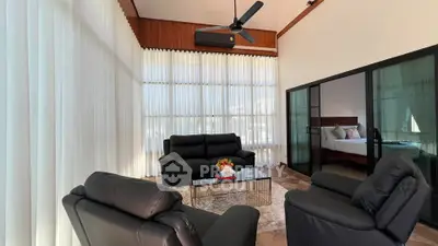 Luxurious living room with high ceilings, modern furniture, and elegant decor in a stylish home.