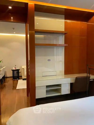 Luxurious modern living room with elegant wooden accents and sleek furniture design.