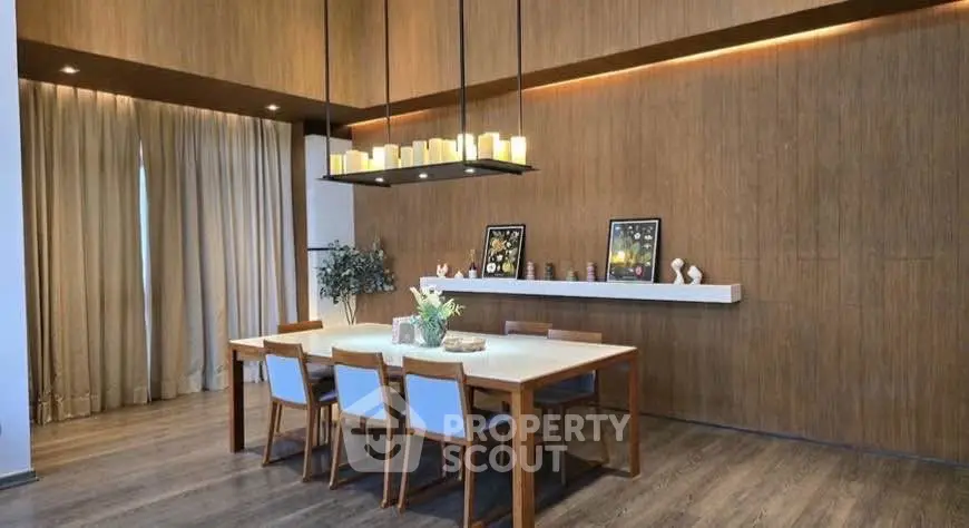 Elegant dining room with modern wooden decor and ambient lighting, perfect for stylish gatherings.