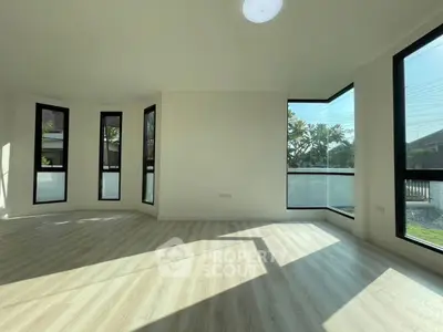 Spacious corner unit living room with large windows and natural light.