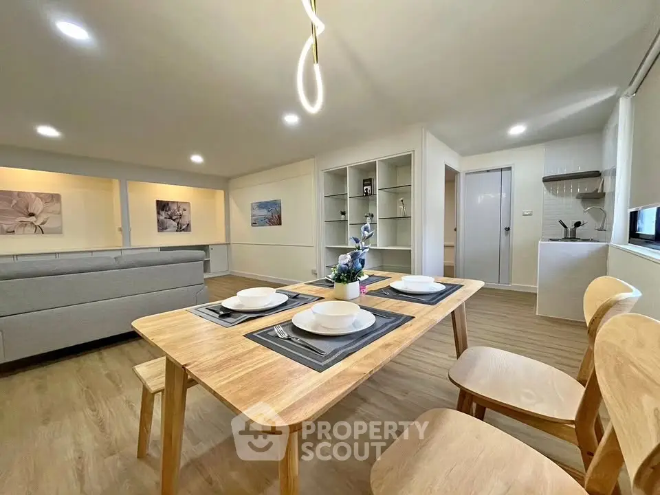 Spacious open-plan living and dining area with modern decor and natural light.