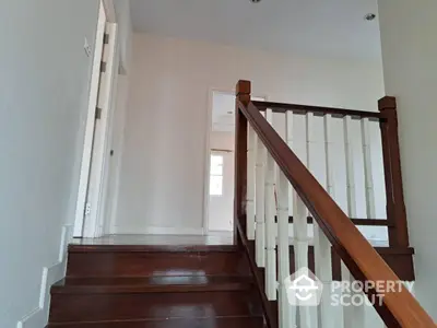 Elegant staircase with wooden railing in modern home interior