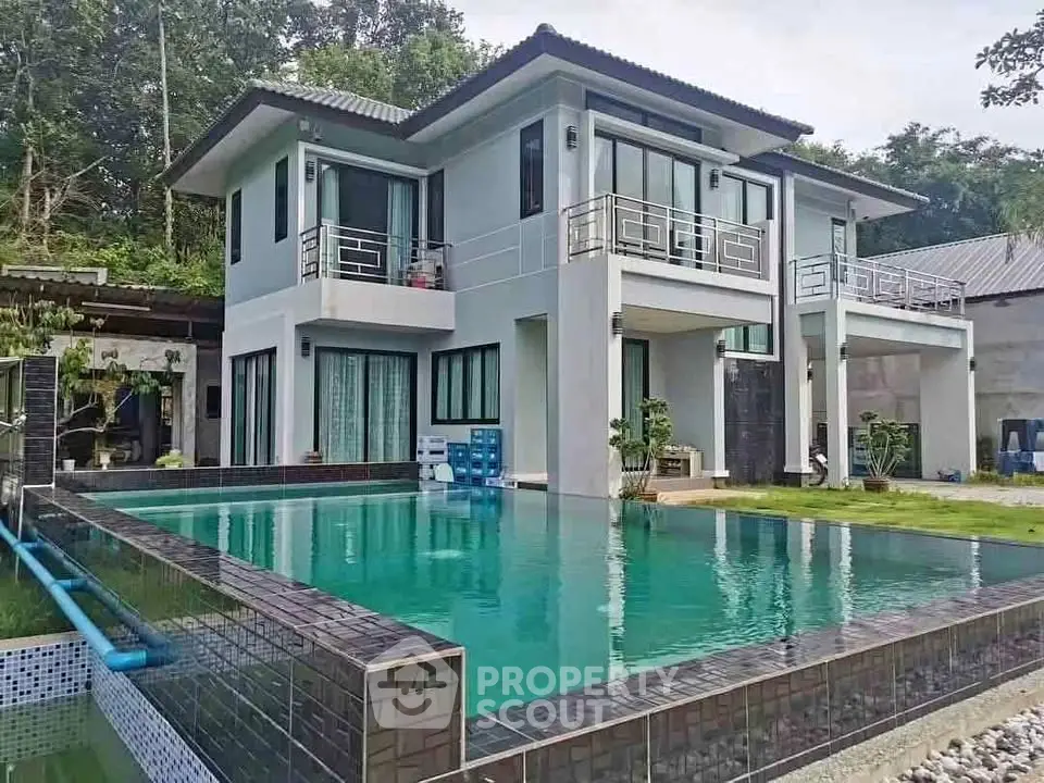 Stunning modern two-story home with pool and lush surroundings, perfect for luxury living.
