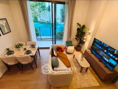 Stylish living room with pool view, modern decor, and cozy seating area.