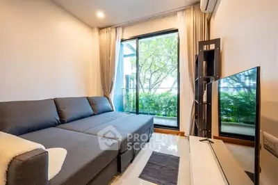 Modern living room with large window and stylish furniture in a cozy apartment.