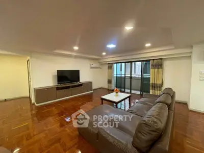 Spacious living room with modern furniture and large windows for natural light.