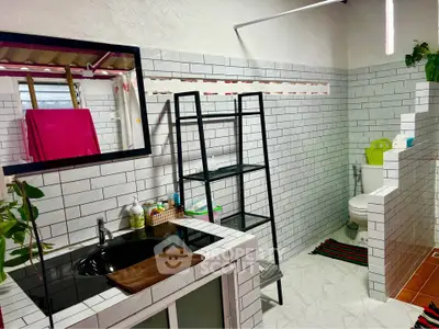 Modern bathroom with sleek black sink and white subway tiles