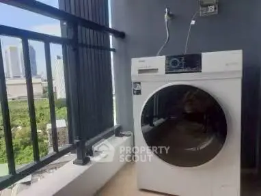Modern balcony with a sleek washing machine and city view, perfect for urban living.