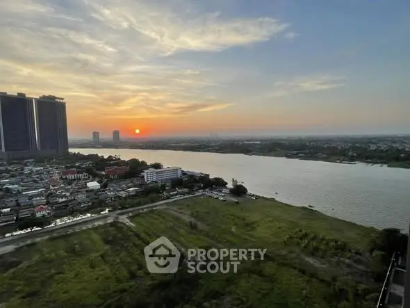 Stunning river view from high-rise building at sunset, perfect for serene living.