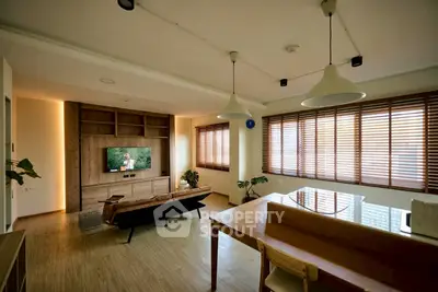 Spacious modern living room with wooden flooring and large windows