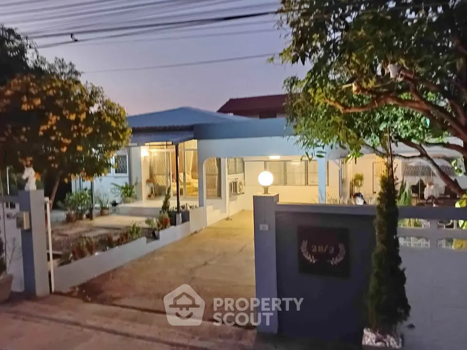 Charming single-story home with spacious driveway and lush garden, perfect for serene living.