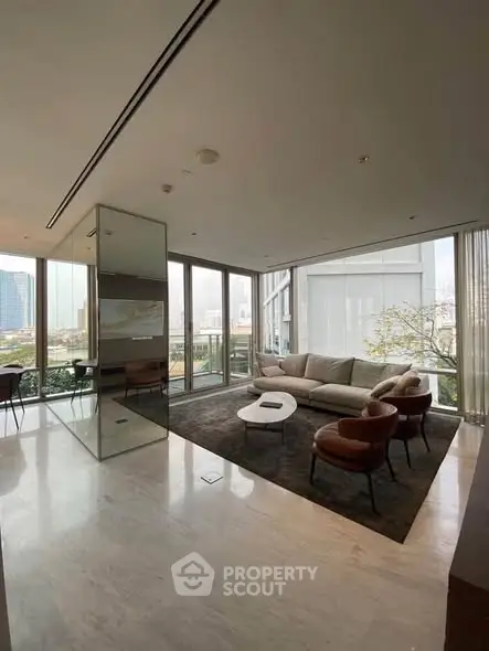 Luxurious modern living room with panoramic city views and elegant furnishings.
