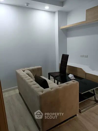 Modern living room with beige sofa and sleek furniture design