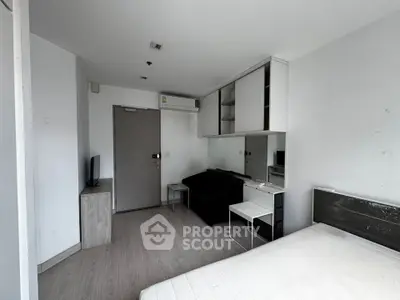 Modern studio apartment with sleek furnishings and ample natural light, perfect for urban living.
