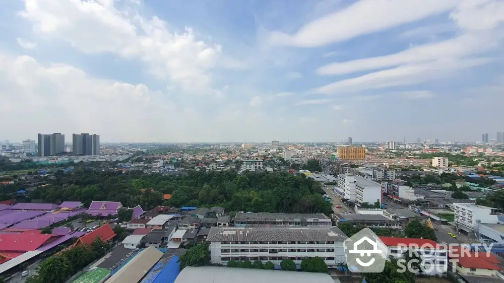 Stunning panoramic cityscape view from high-rise building showcasing urban skyline and lush greenery.