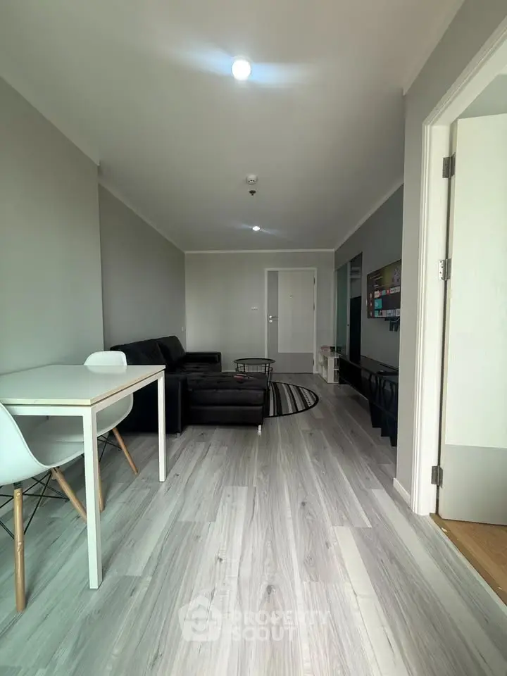 Modern living room with sleek flooring and stylish furniture in a contemporary apartment.