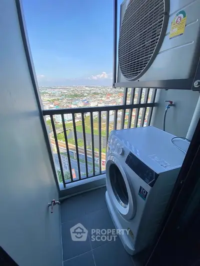 High-rise apartment balcony with washing machine and stunning city view.