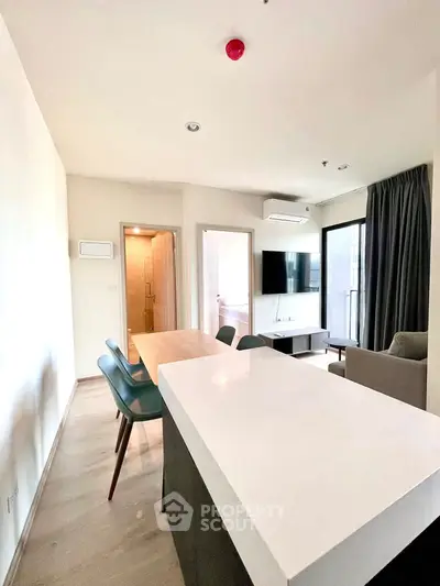 Modern living room with open layout and stylish furniture in a bright apartment.