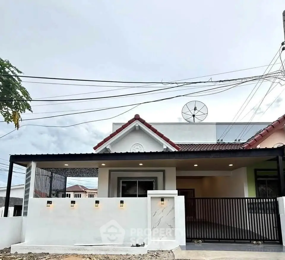 Charming single-story home with modern facade and gated entrance, perfect for family living.
