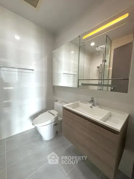 Modern bathroom with sleek fixtures and large mirror
